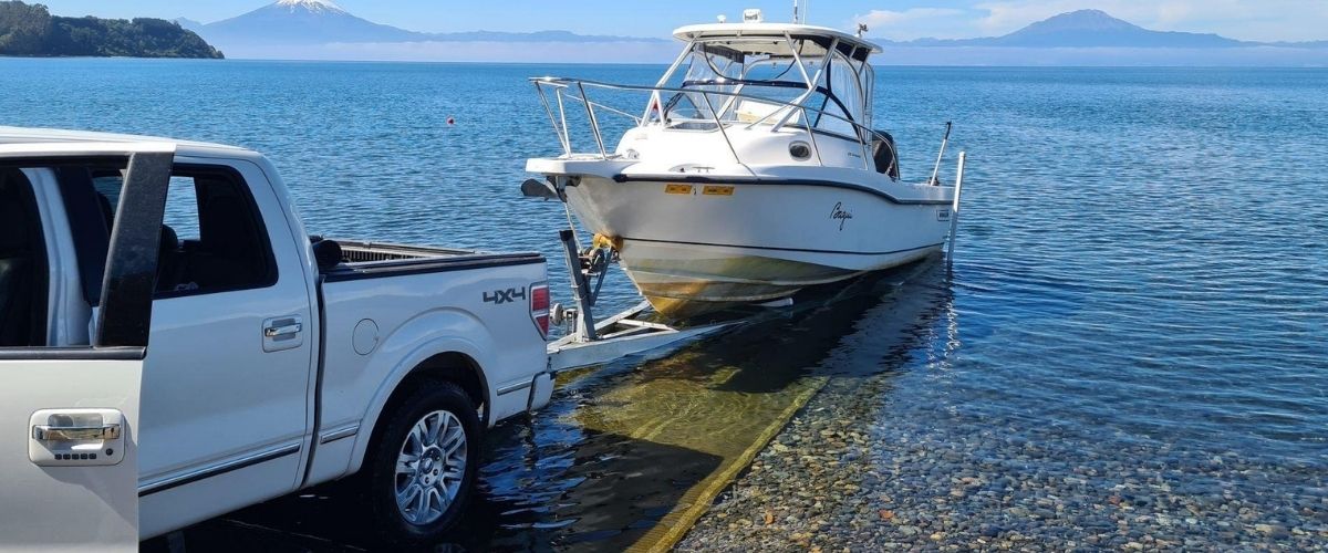 Mobi-mat® Boatramp™ portable boat launch ramp deployed on a lakeshore with a 4x4 pickup launching a boat
